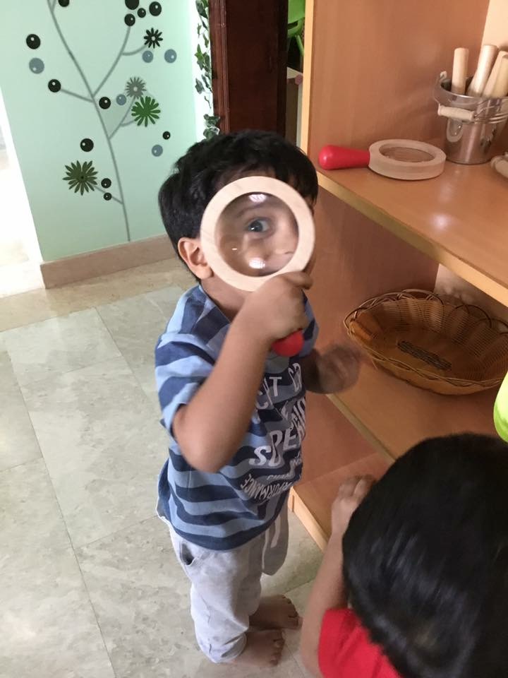Child with magnifying glass